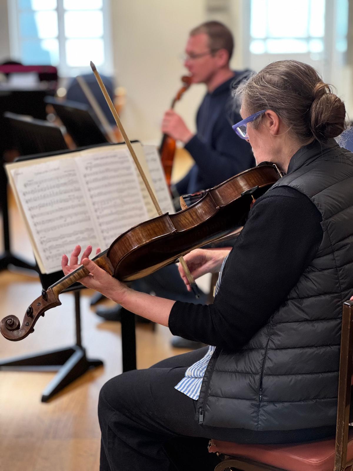 Adults practicing with instruments