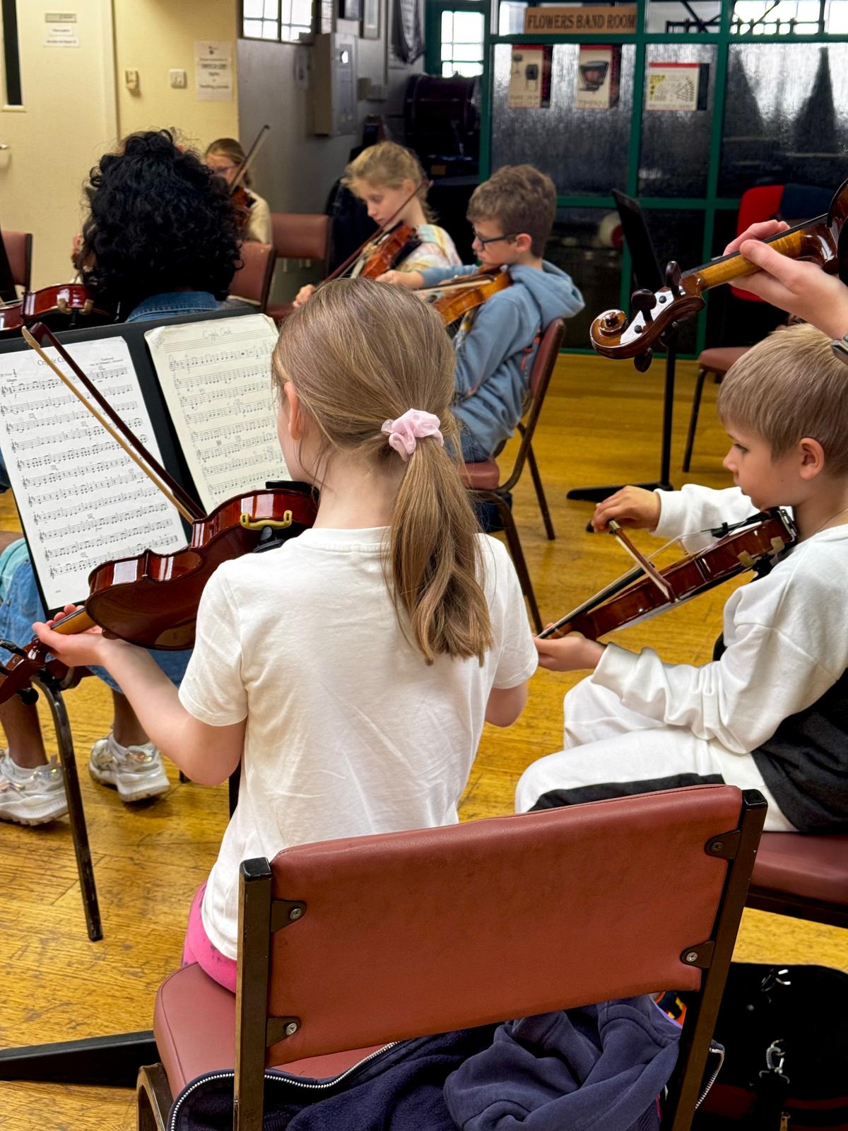 Young people holding instruments