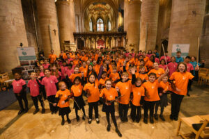 Large group of musicians with instruments smiling
